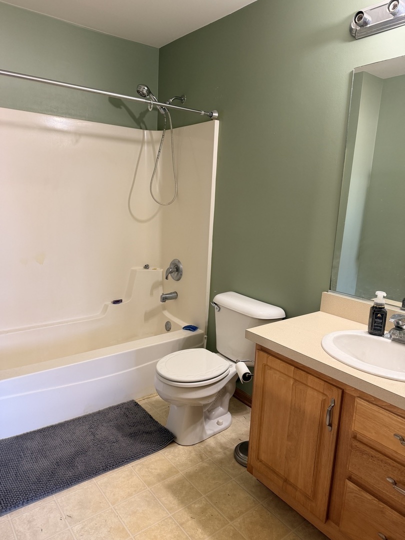 701 Davidson Drive, Unit B Minooka, IL 60447 - Photo 11 of 16 a bathroom with a sink toilet and shower