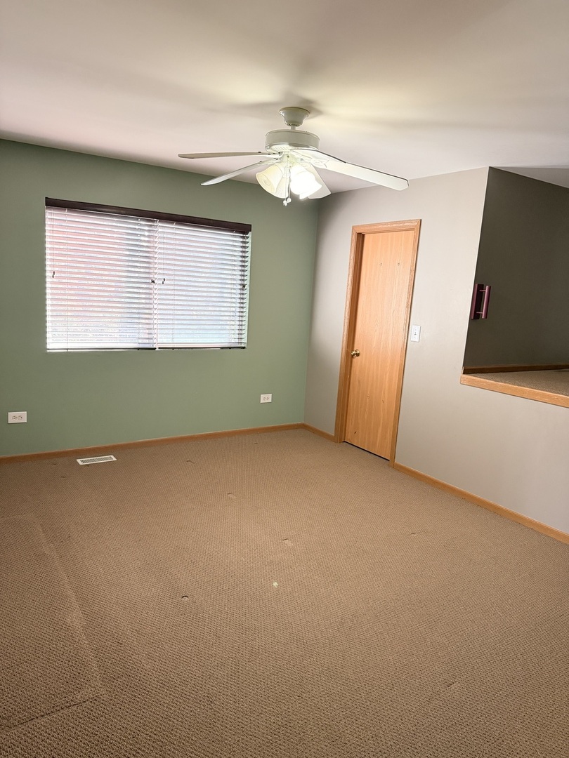 701 Davidson Drive, Unit B Minooka, IL 60447 - Photo 12 of 16 an empty room with window and fan