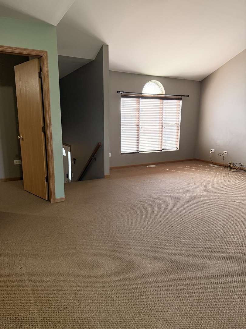 701 Davidson Drive, Unit B Minooka, IL 60447 - Photo 6 of 16 an empty room with windows and closet