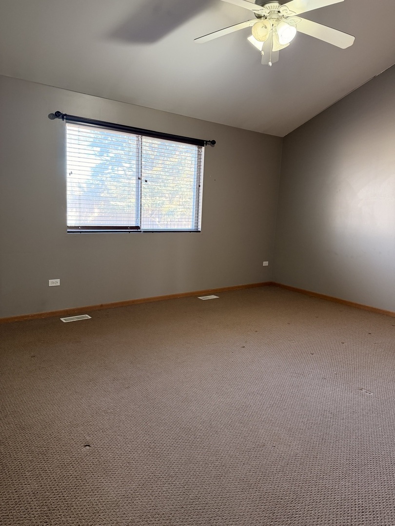 701 Davidson Drive, Unit B Minooka, IL 60447 - Photo 9 of 16 an empty room with a window