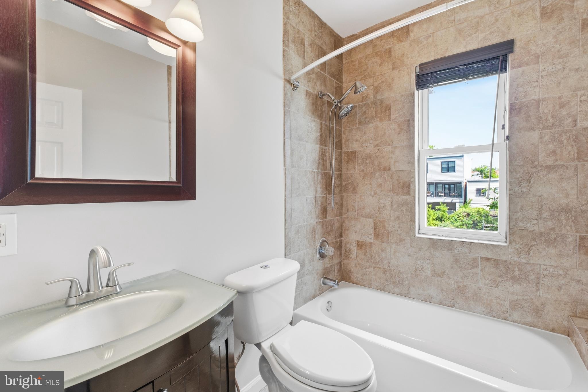 2712 6th Street Northeast Washington, DC 20017 - Photo 12 of 24 a bathroom with a sink toilet a bathtub and a vanity