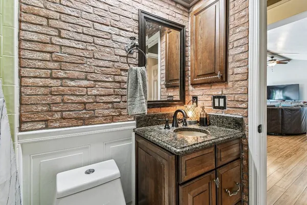 a spacious bedroom with a bed a couch and a chandelier