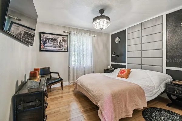 a bedroom with furniture and a flat screen tv