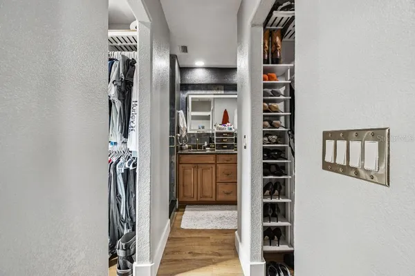 a bathroom with a granite countertop sink a mirror and shower