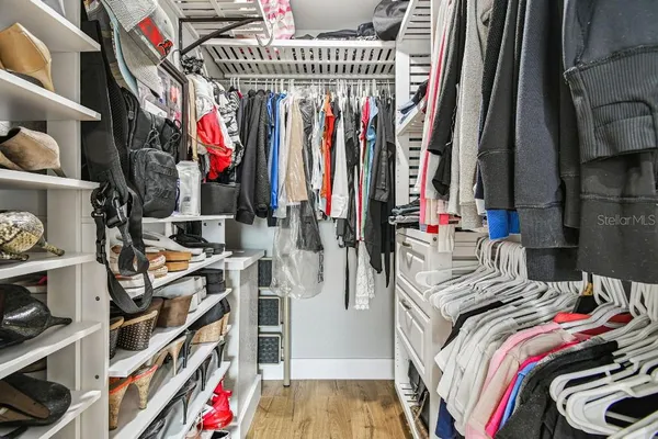 a bathroom with a granite countertop sink a mirror and shower