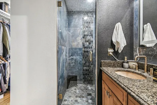 a large white kitchen with lots of counter space dining table and chairs