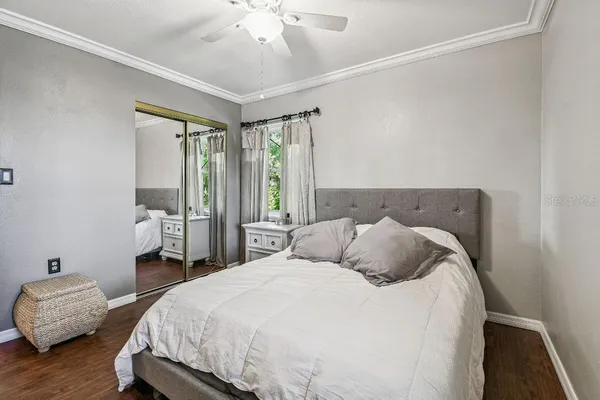 a bedroom with a bed and wooden floor