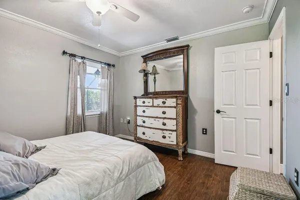 a view of a hallway with wooden floor and stairs