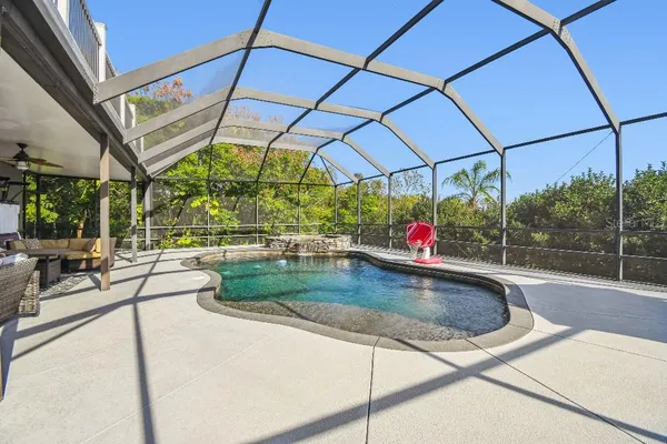 a view of a balcony with two chairs and wooden floor