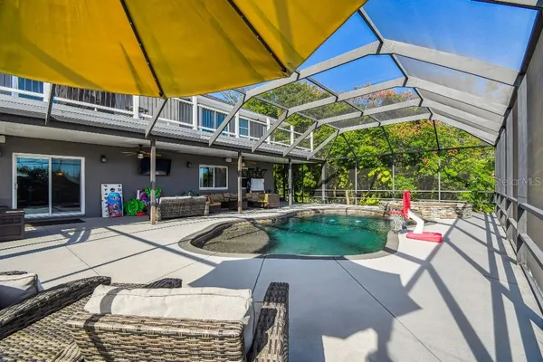 a view of a house with a yard and a garage