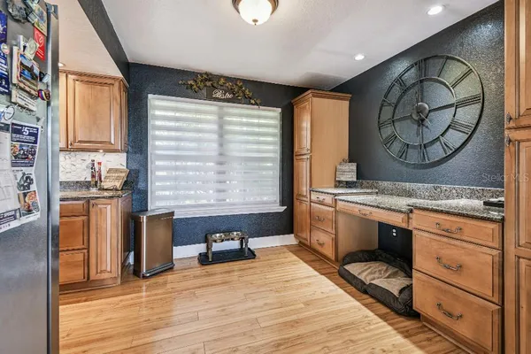 a kitchen with granite countertop stainless steel appliances white cabinets and a sink