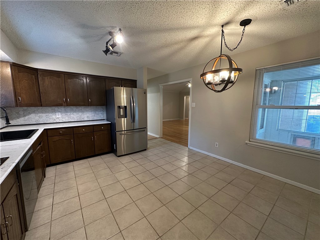 1506 Briar Street Portland, TX 78374 - Photo 11 of 40 a kitchen with stainless steel appliances granite countertop a sink window and cabinets
