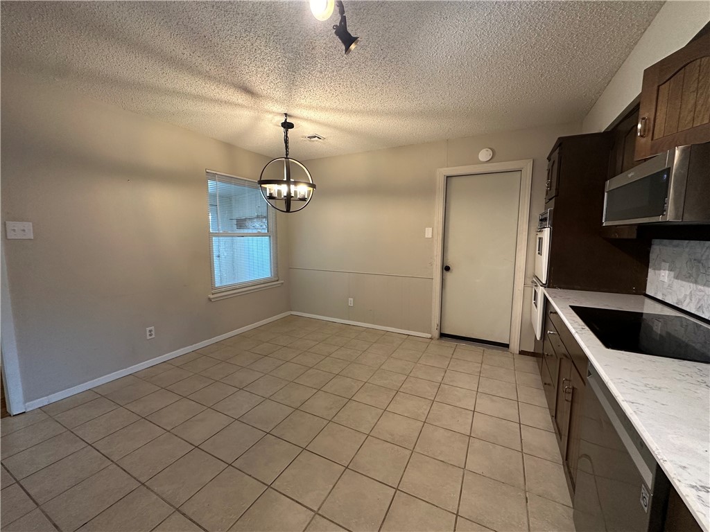 1506 Briar Street Portland, TX 78374 - Photo 12 of 40 a view of a kitchen with a sink and dishwasher in white cabinet