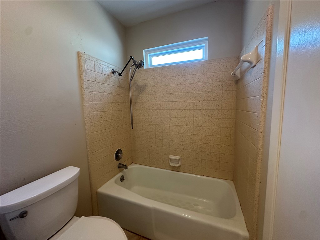 1506 Briar Street Portland, TX 78374 - Photo 21 of 40 a white bath tub sitting next to a toilet