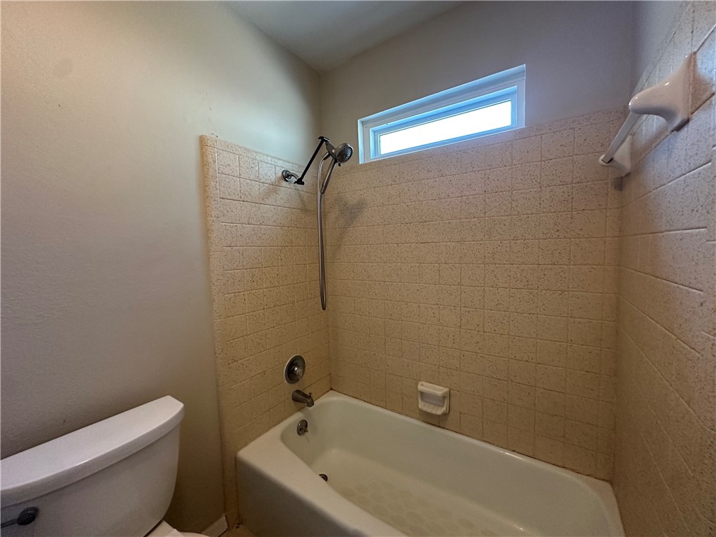 1506 Briar Street Portland, TX 78374 - Photo 22 of 40 a bathroom with a bathtub and toilet