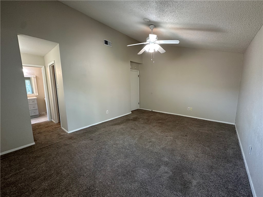 1506 Briar Street Portland, TX 78374 - Photo 30 of 40 an empty room with a chandelier fan and wooden floor