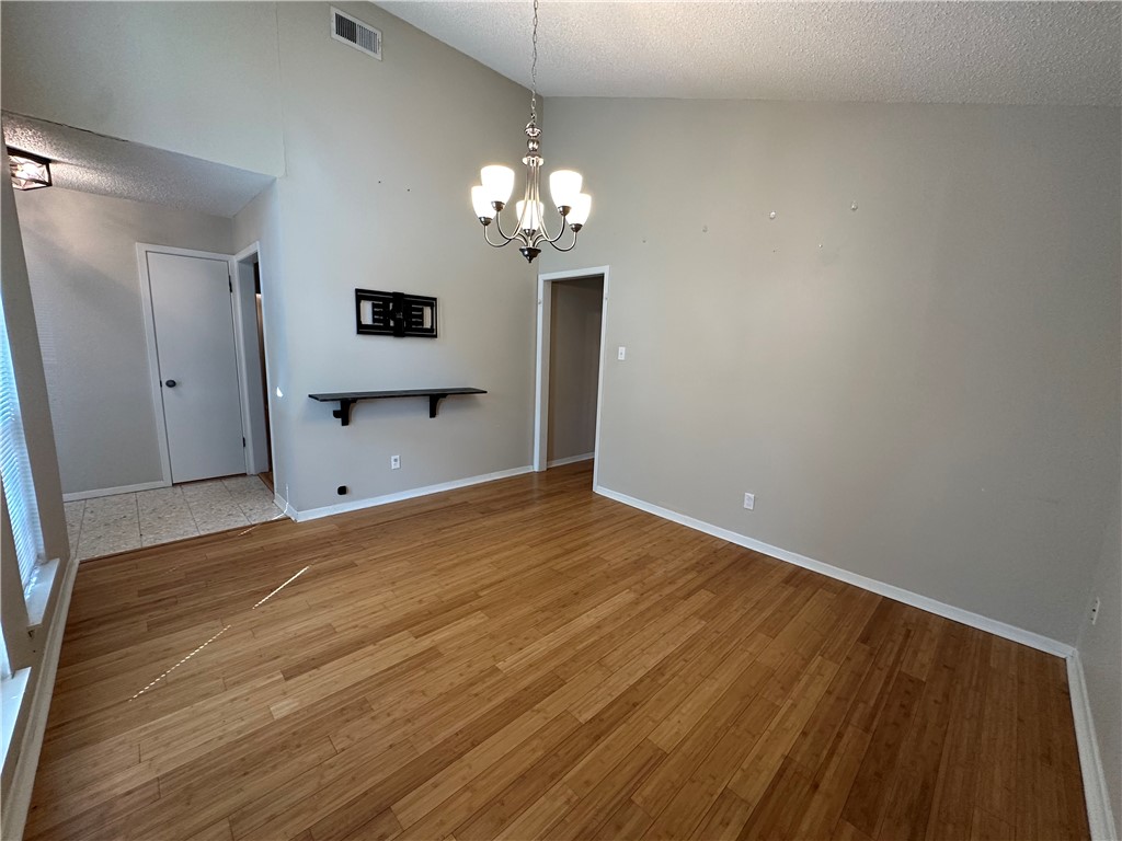 1506 Briar Street Portland, TX 78374 - Photo 3 of 40 a view of a room with wooden floor and chandelier