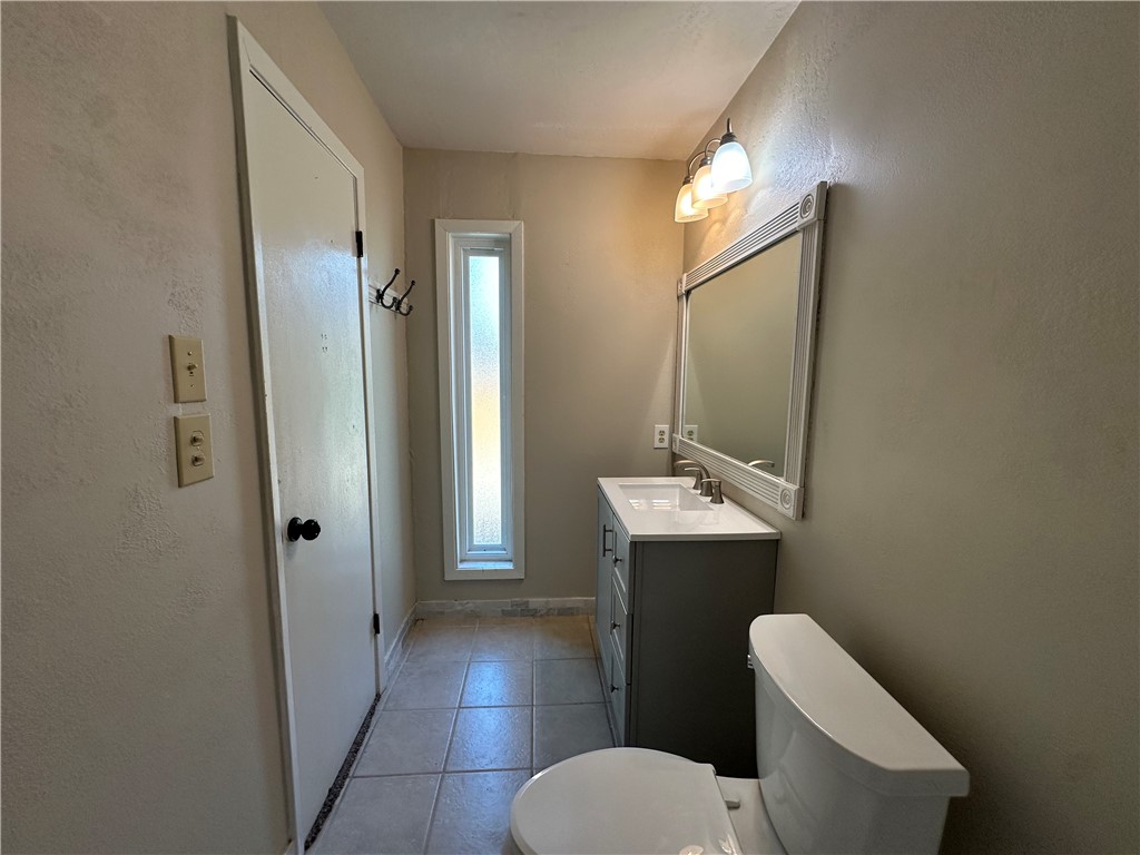 1506 Briar Street Portland, TX 78374 - Photo 36 of 40 a bathroom with a toilet sink and mirror
