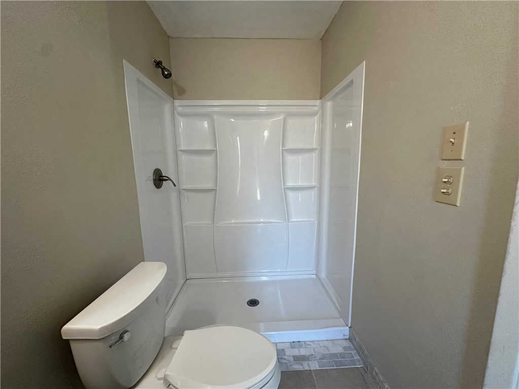 1506 Briar Street Portland, TX 78374 - Photo 37 of 40 a white toilet sitting next to a bathroom