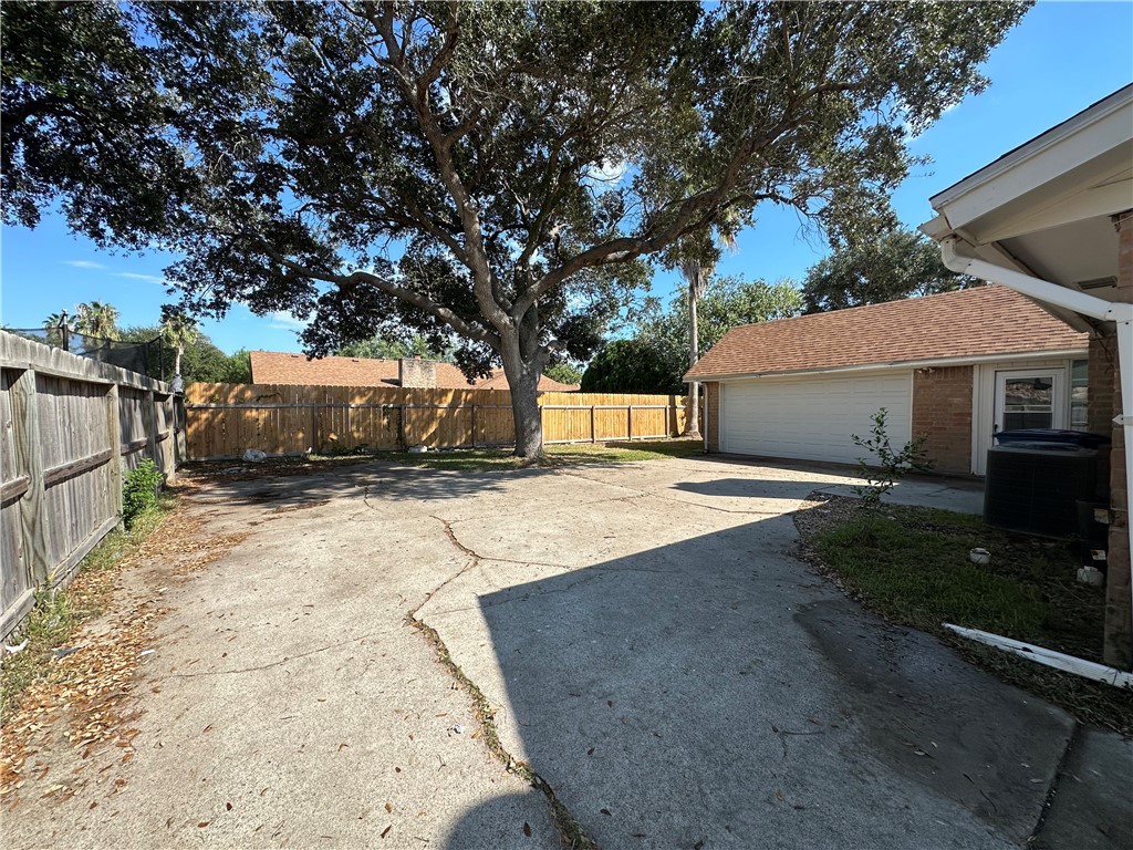 1506 Briar Street Portland, TX 78374 - Photo 39 of 40 a view of a white house with a large tree