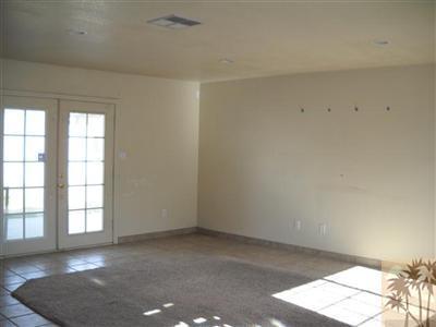 82130 Adobe Road Indio, CA 92201 - Photo 3 of 11 an empty room with windows