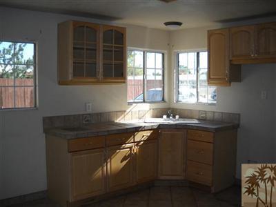 82130 Adobe Road Indio, CA 92201 - Photo 5 of 11 a kitchen with a sink stove and cabinets
