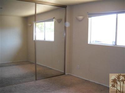 82130 Adobe Road Indio, CA 92201 - Photo 6 of 11 an empty room with windows and closet