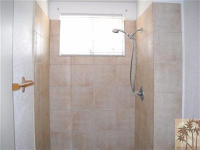82130 Adobe Road Indio, CA 92201 - Photo 7 of 11 a bathroom with a glass shower door