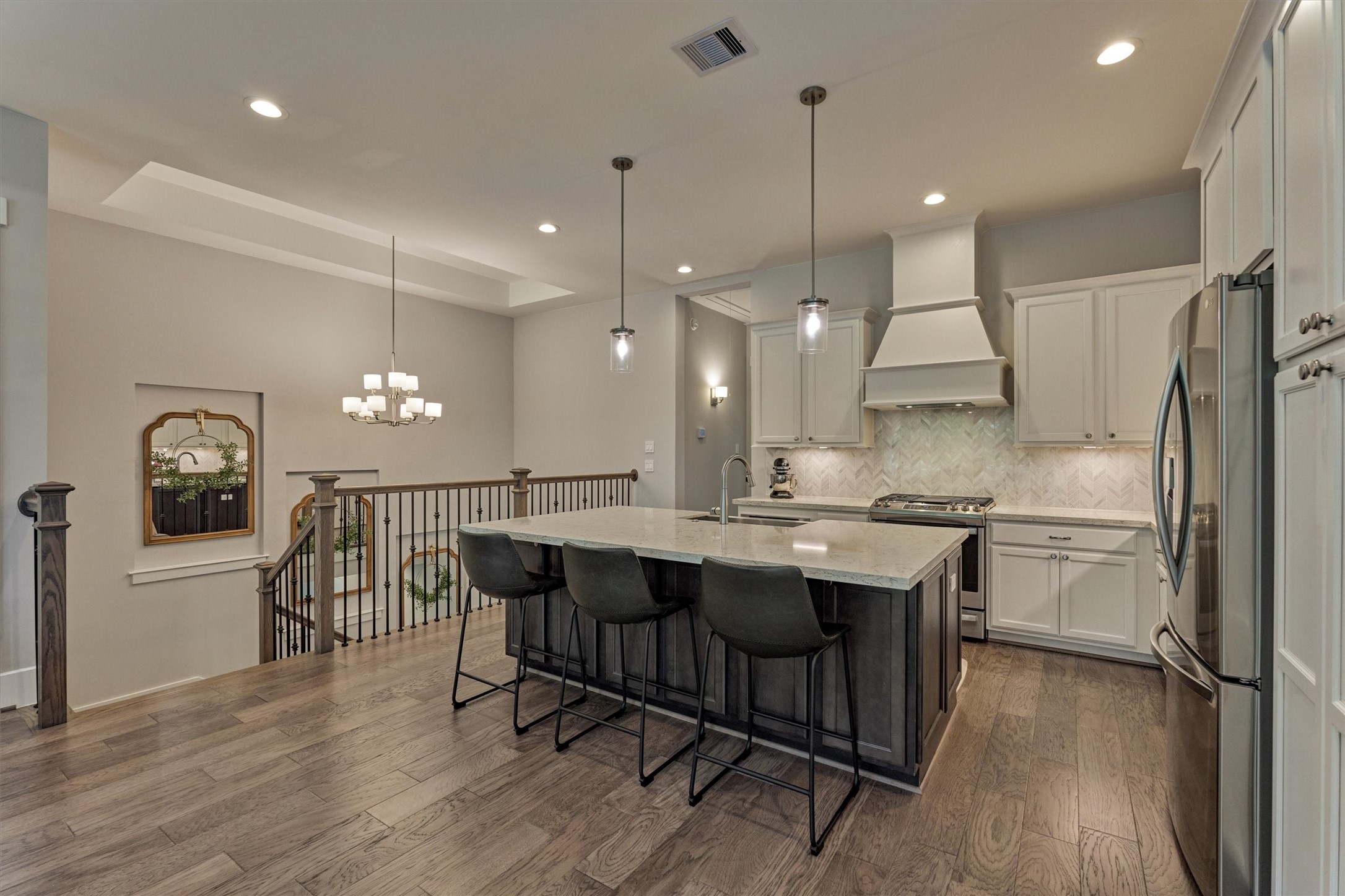 62 Dobbs View Lane Spring, TX 77389 - Photo 7 of 42 a kitchen with a sink a refrigerator and chairs