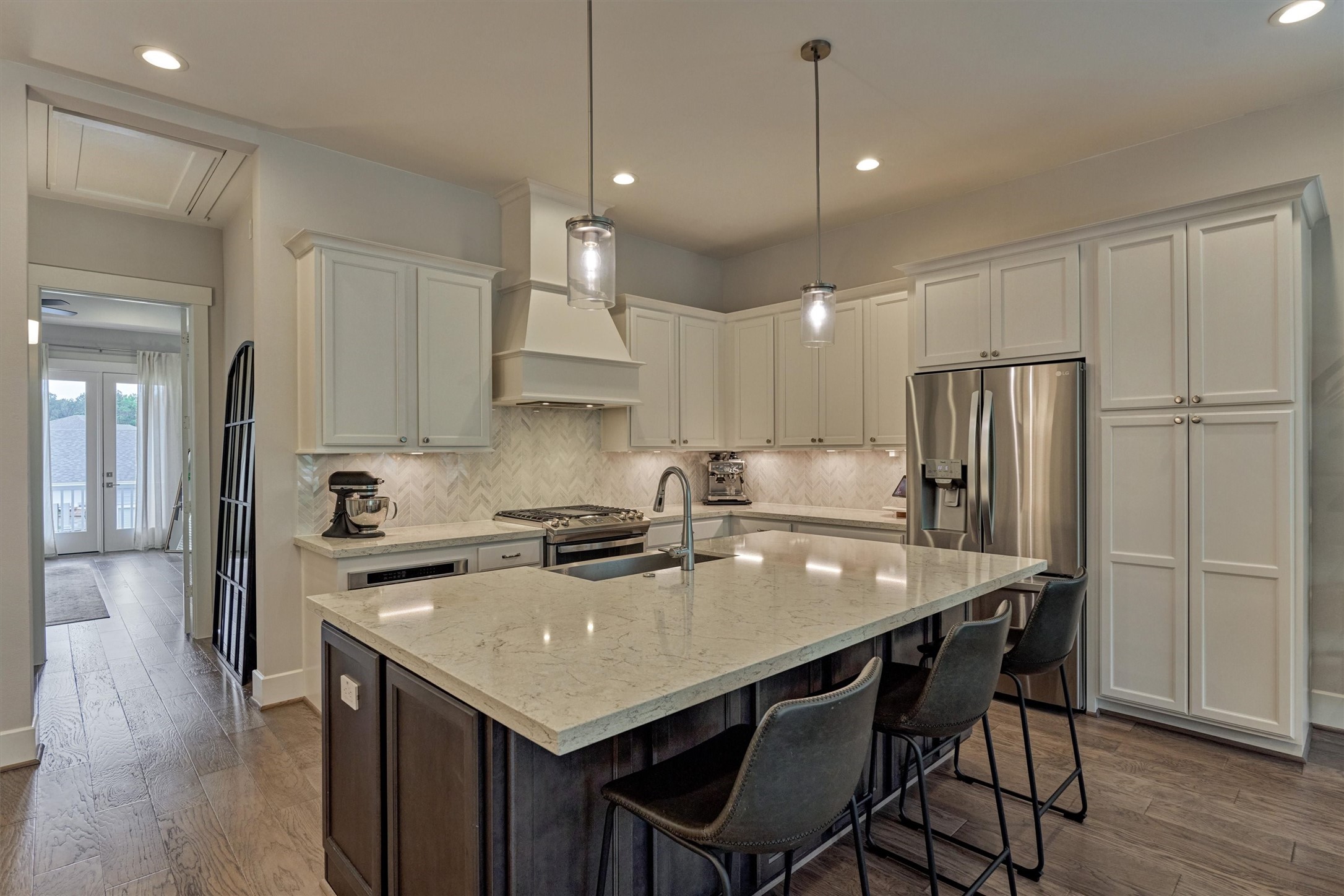 62 Dobbs View Lane Spring, TX 77389 - Photo 9 of 42 a kitchen with a table chairs refrigerator and microwave