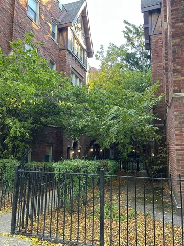 a front view of a house with a yard and lake view