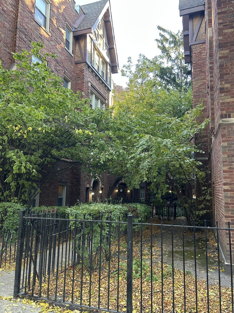4955 North Whipple Street, Unit 3E Chicago, IL 60625 - Photo 1 of 1 a front view of a house with a yard and lake view