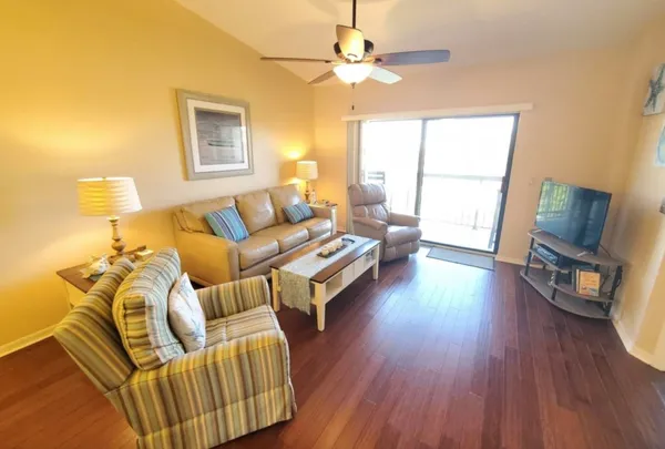 a living room with furniture and a wooden floor