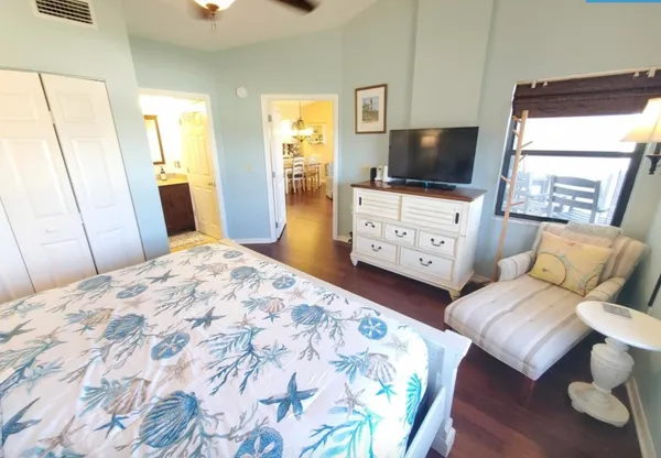 a bedroom with furniture and a flat screen tv