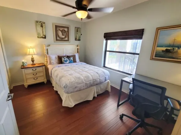 a bedroom with a bed and a chandelier