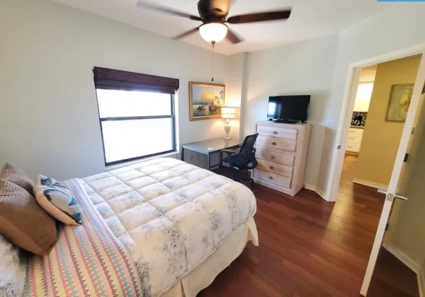 a bedroom with a bed and a flat screen tv