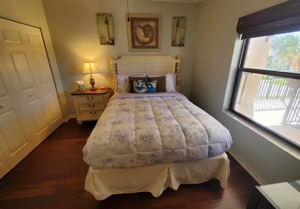 a bed sitting in a bedroom next to a window