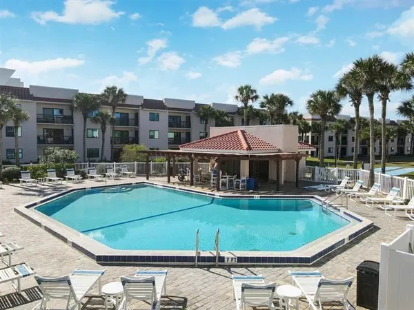 a view of a swimming pool with chairs