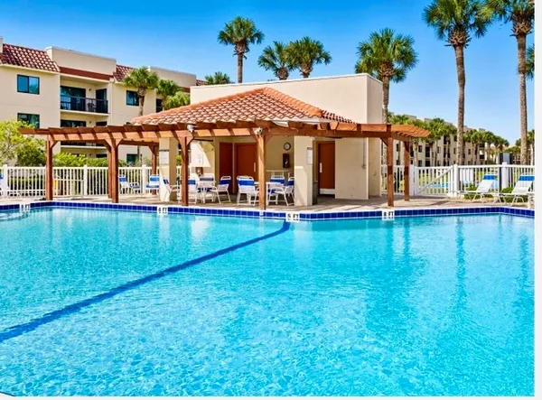 a view of a house with swimming pool and sitting area