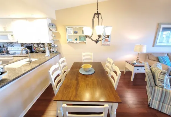 a kitchen with stainless steel appliances granite countertop a sink a stove and a refrigerator