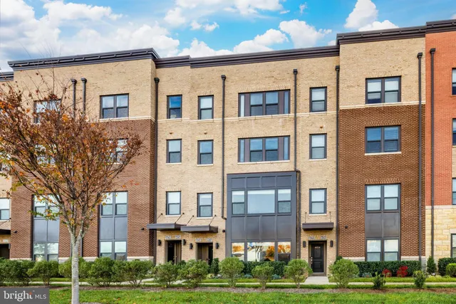 a front view of a residential apartment building with a yard