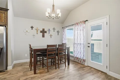 a view of a dining room with furniture wooden floor and chandelier
