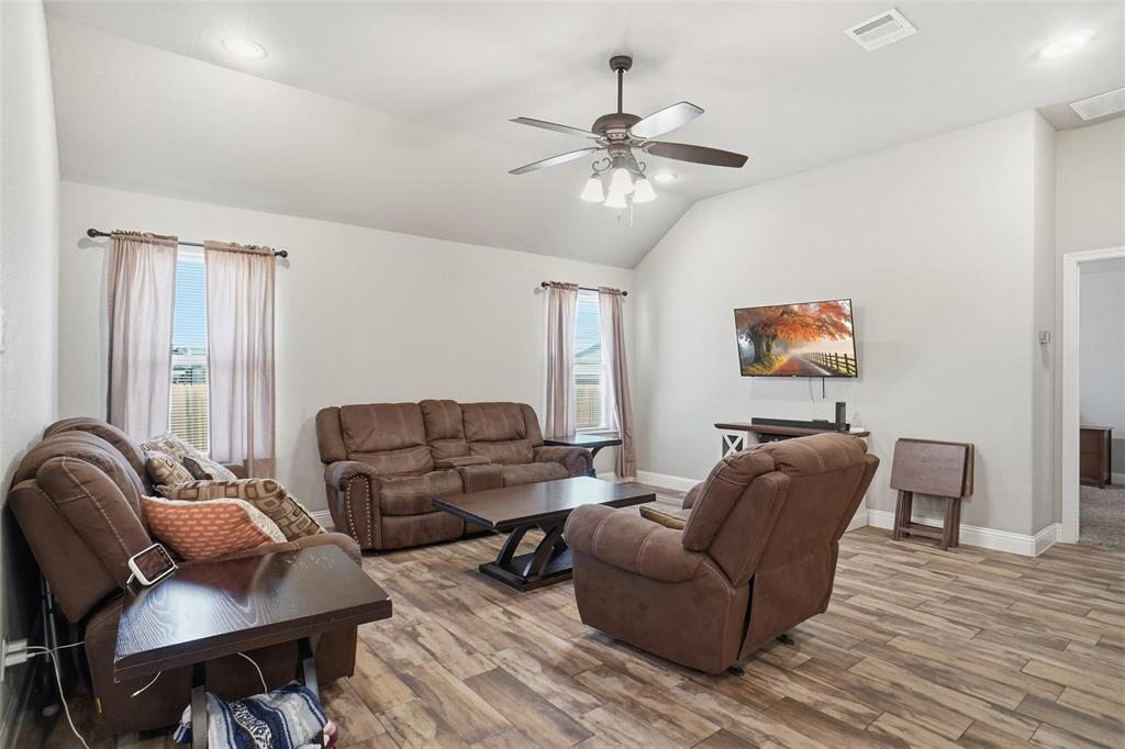 206 McKittrick Lane Godley, TX 76044 - Photo 12 of 28 Living room featuring vaulted ceiling, light wood-style flooring, ceiling fan, and recessed lighting
