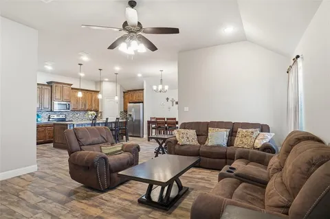 a living room with furniture ceiling fan and a rug