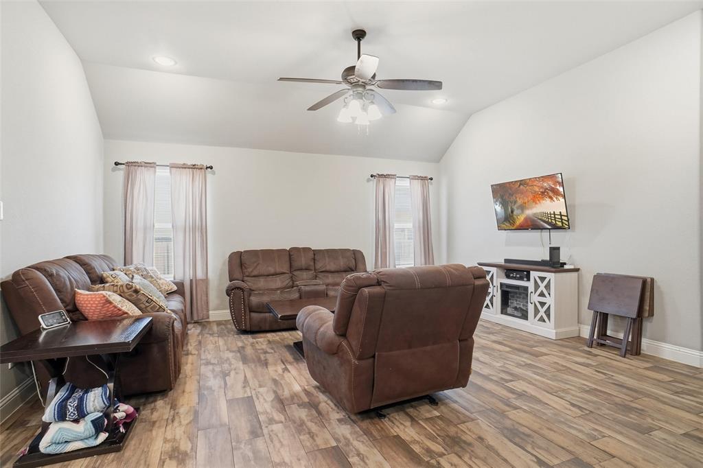 206 McKittrick Lane Godley, TX 76044 - Photo 15 of 28 Living room with lofted ceiling, light wood finished floors, a ceiling fan, and recessed lighting
