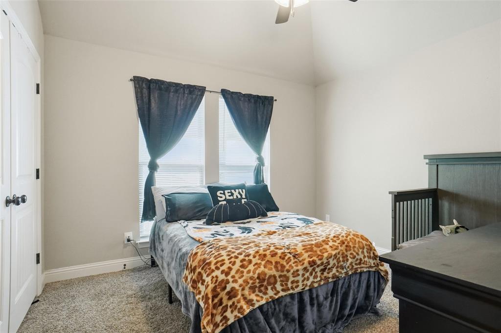 206 McKittrick Lane Godley, TX 76044 - Photo 21 of 28 Carpeted bedroom with a closet, ceiling fan, and lofted ceiling