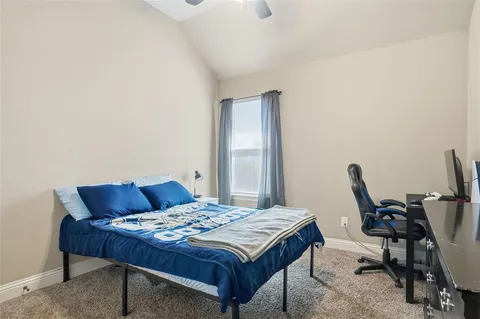 a bedroom with a bed and a desk