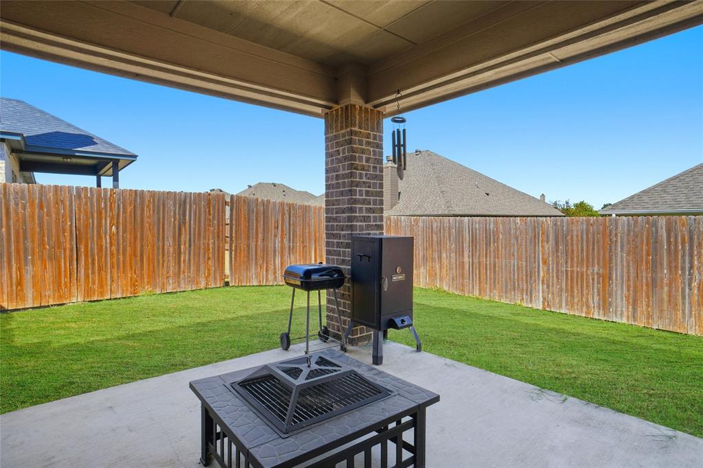 206 McKittrick Lane Godley, TX 76044 - Photo 26 of 28 Fenced backyard featuring a patio area and grilling area