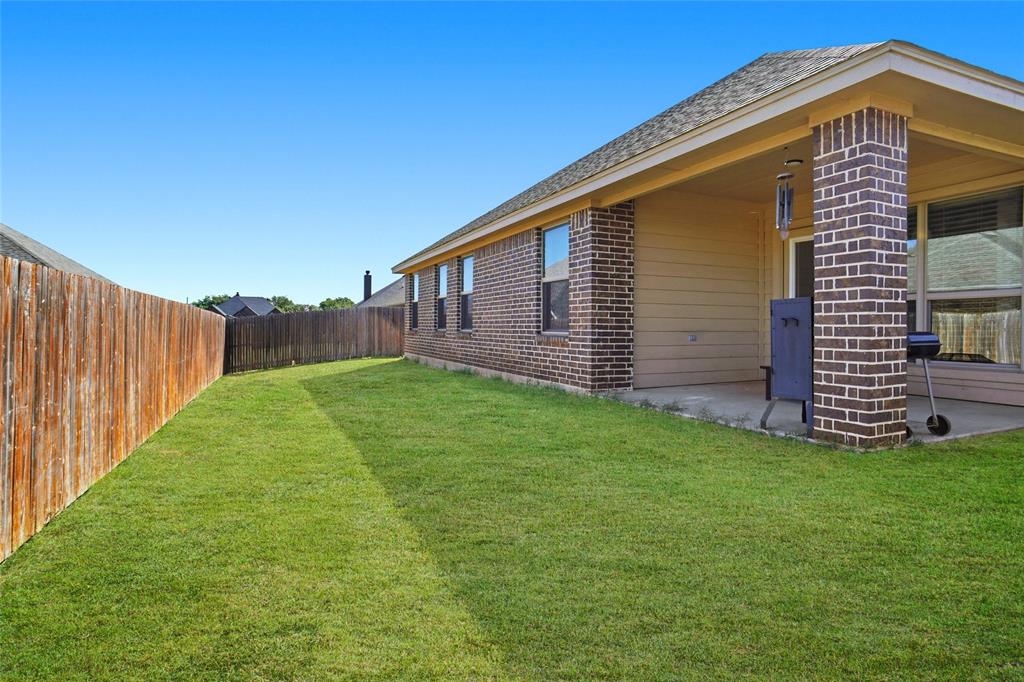 206 McKittrick Lane Godley, TX 76044 - Photo 27 of 28 Fenced backyard featuring a patio