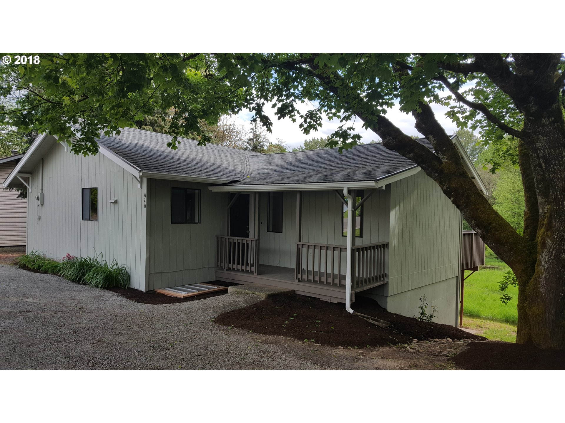 1940 Northeast 3rd Loop Camas, WA 98607 - Photo 1 of 22 a black and white house with a large tree in the background